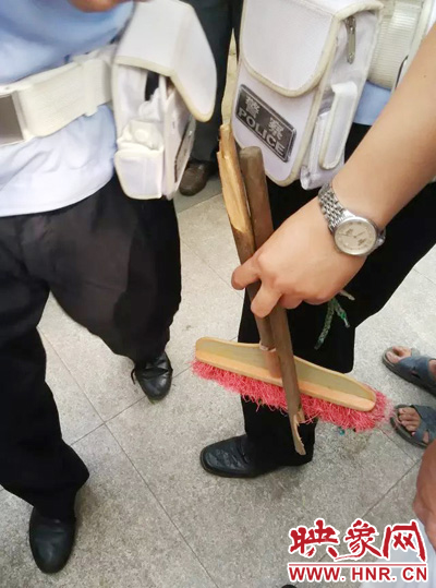 老太從環(huán)衛(wèi)工手中奪過掃帚，用腳踩斷，用力向環(huán)衛(wèi)工人的手上和腿上敲去。