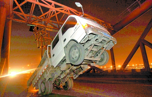 　車上升降機的工作臺被卡，車身前部高高翹起。