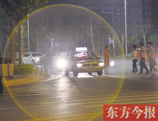 昨晚，鄭州火車東站，一些出租車停靠在路邊，見到行人不時主動搭訕 東方今報暗訪組 攝