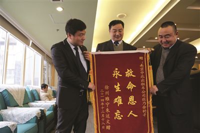 張乃余(中)和兩位救人的同伴一塊領(lǐng)獎。