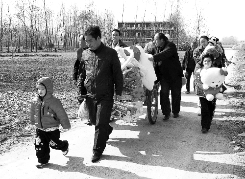 姐（左一）弟（右一護(hù)士懷中男嬰）返鄉(xiāng)，愛心捐贈滿滿一架子車。